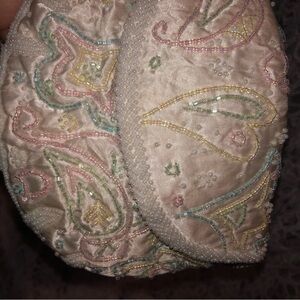 Cream Clutch with Intricate Paisley Pattern and Textured Finish